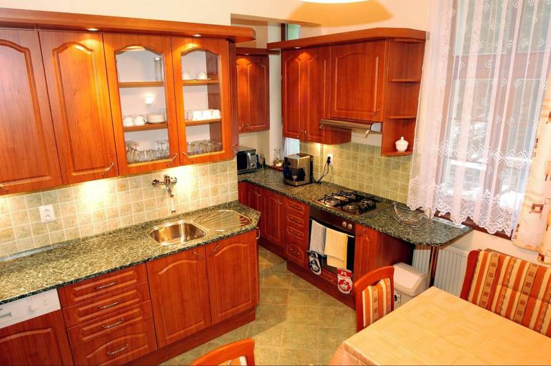 Wooden kitchen in hotels and guesthouses with a dining table and appliances.