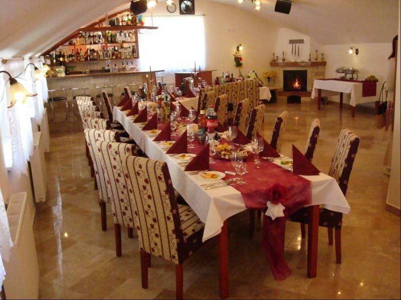 A restaurant room with a table set for a feast, decorated in hotel style.