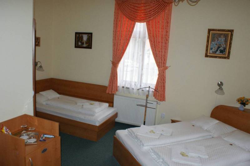 A room with two beds, curtains, paintings, interior of hotels and guesthouses.