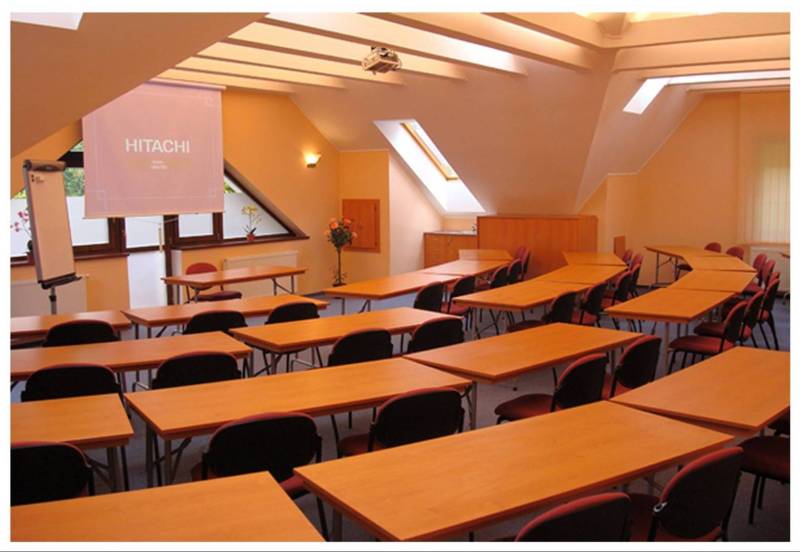 Conference room with wooden tables and chairs within hotels and guesthouses.