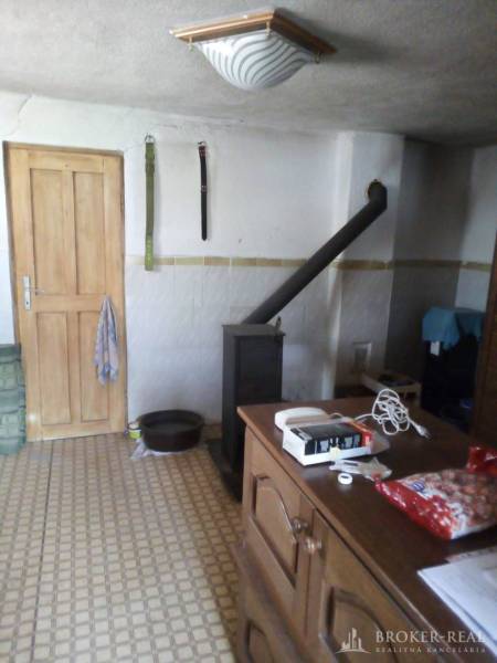 The interior of a family house with tiles, wooden doors, and patterned flooring.