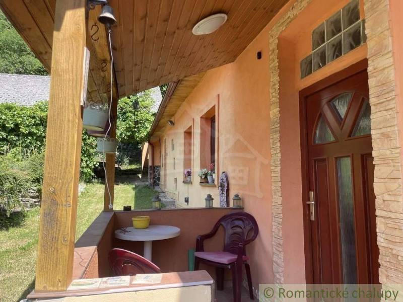 A family house in Medzev with a wooden terrace and ornamental garden, peaceful atmosphere.