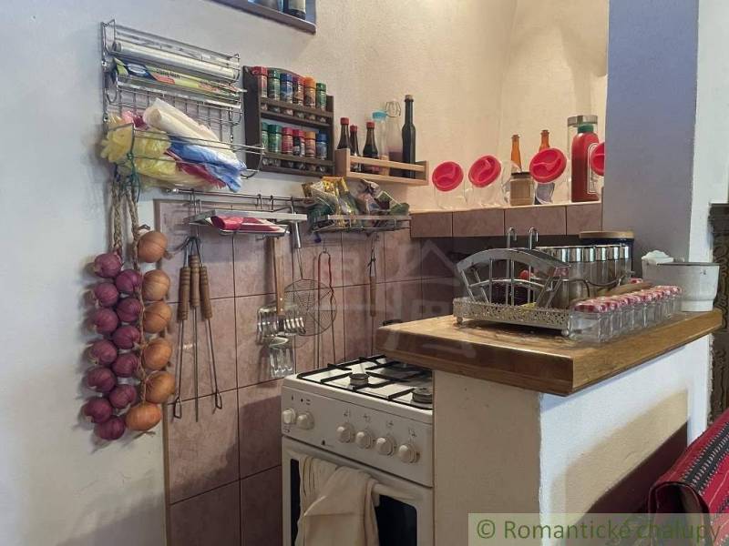 Traditional kitchen in a family house with spices, onions, and kitchenware.