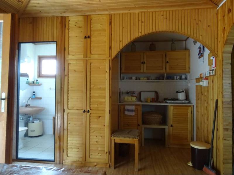 Interior of a family house with wooden cabinets and a view of the bathroom.