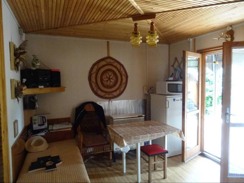 Bright room in a family house with a table, chairs, and decorations on the walls.