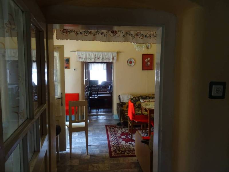 Traditional interior of a family house with a carpet and furniture in warm colors.