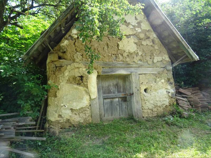 An old shed made of clay and wood in the garden of a family house in Tornaszentandrás.
