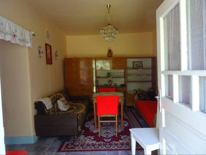 Living room in a family house with retro furniture and decorations on the walls.
