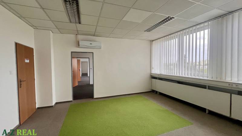 A spacious office with air conditioning, green carpet, and large windows on Drieňová in Ružinov.