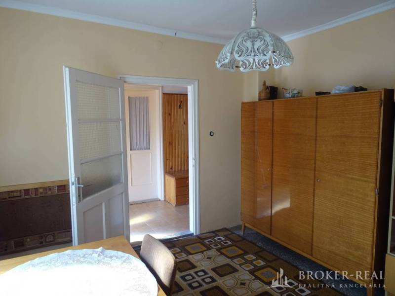 Interior in a family house with a wooden wardrobe and a connecting hallway.