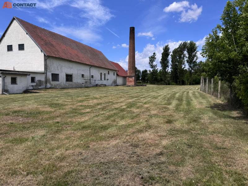 A building on Zemianske Sady street in Zemianske Sady with a chimney, surrounded by a lawn.