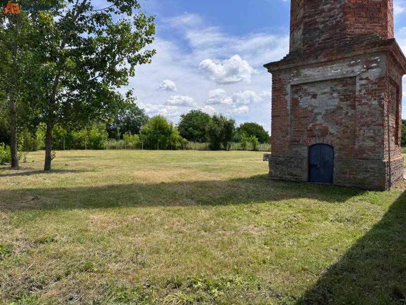 A grassy area with a brick building on Zemianske Sady street in Zemianske Sady.