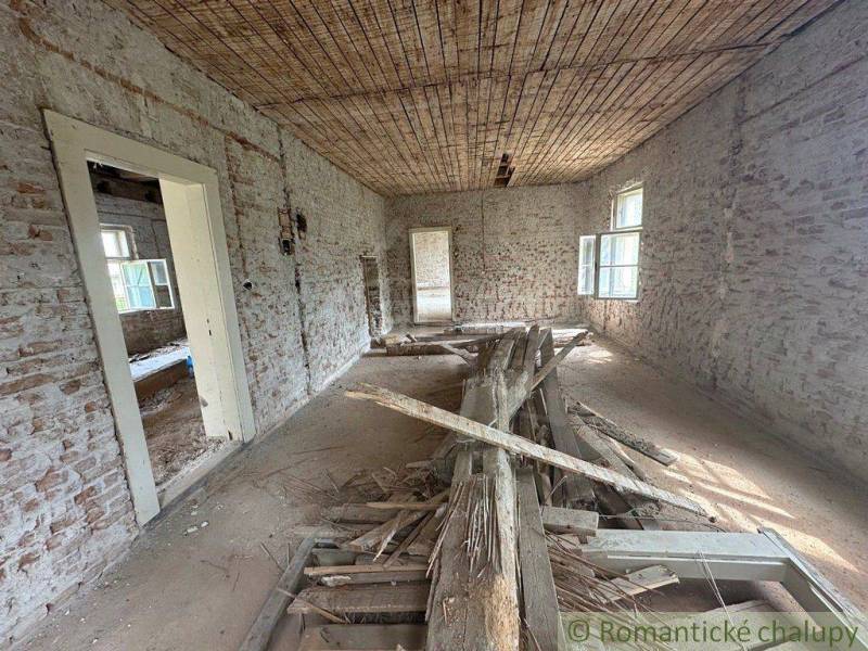 Interior of a family house with brick walls and a broken floor.