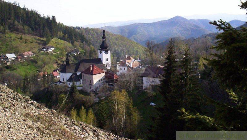 Gardens in Banská Bystrica depict a picturesque village with a church surrounded by forests and mountains.