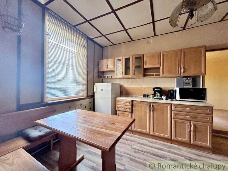 A kitchen in a family house with wooden furniture and appliances.