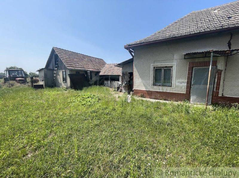 A family house in Nové Zámky with an older rural style surrounded by a grassy plot.