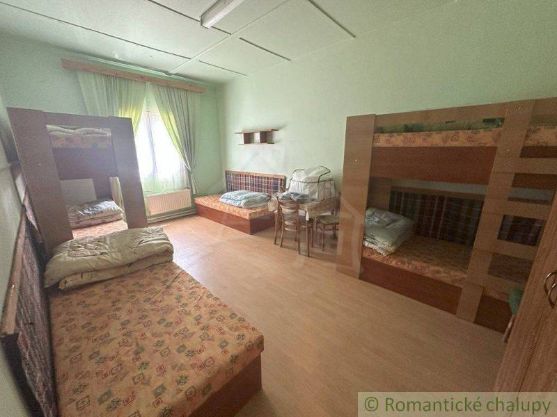 Bedroom with bunk beds and furniture in a family house, light green wall.