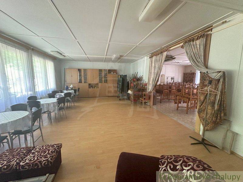 Interior of a family house with a dining area and tables for seating.