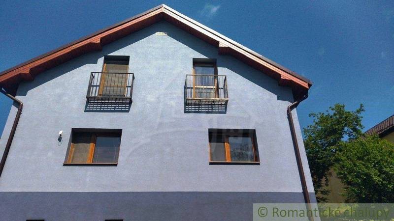 A family house in Spišská Nová Ves with a blue facade and balconies.