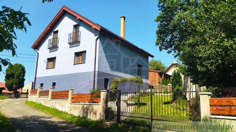 A family house in Spišská Nová Ves with a garden and fencing on a quiet street.