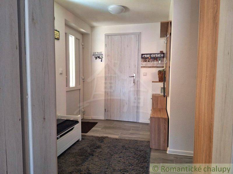 Entrance hallway with carpet and wooden furniture in a family house.