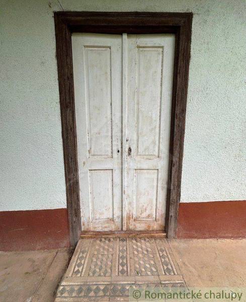 Old wooden door and tiles in a cottage in Nové Zámky.