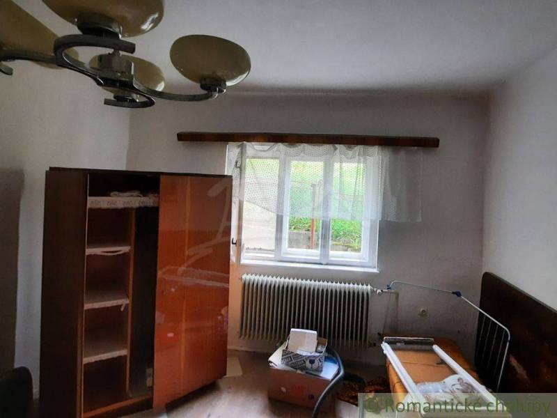 A room in a family house with simple furniture and a window, a bright space.