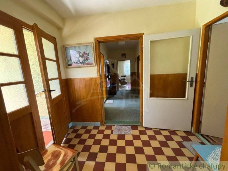 Family house with tiled hallway and glass doors, wall decoration.