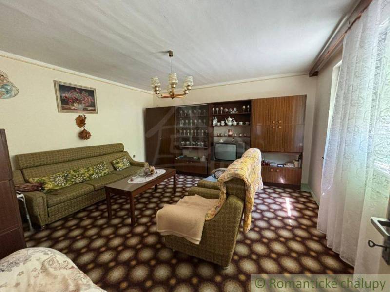 Living room in a family house with retro furniture and decorative elements.