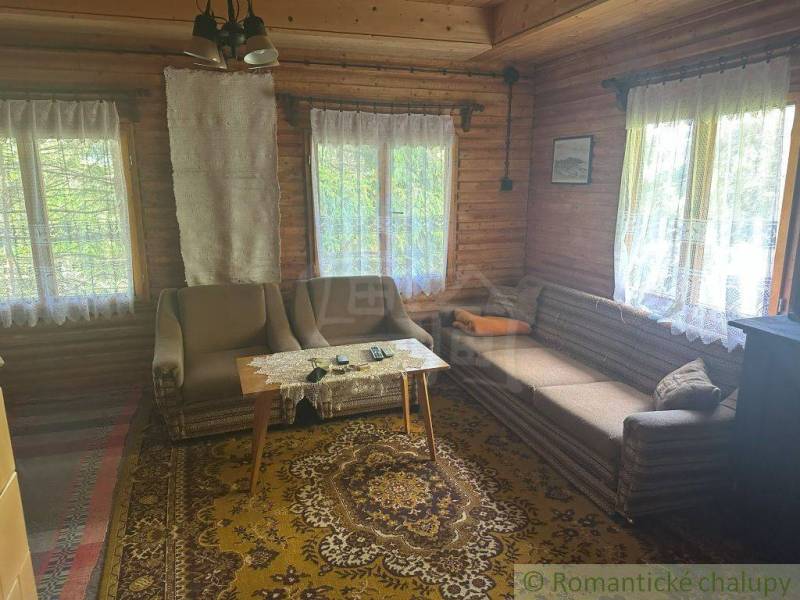 A traditional cottage interior with wooden paneling and rustic furniture.