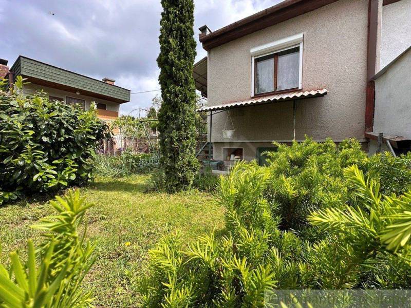 A cottage in Nové Zámky surrounded by greenery and a landscaped garden.