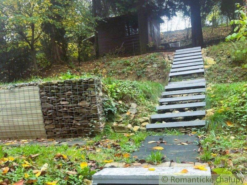 A cottage in Bratislava - Lamač, stairs leading through a green slope, natural surroundings.