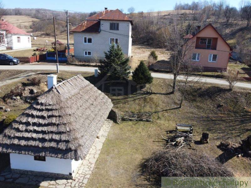 A family house in Nová Sedlica with a traditional roof and surrounding houses in the background.