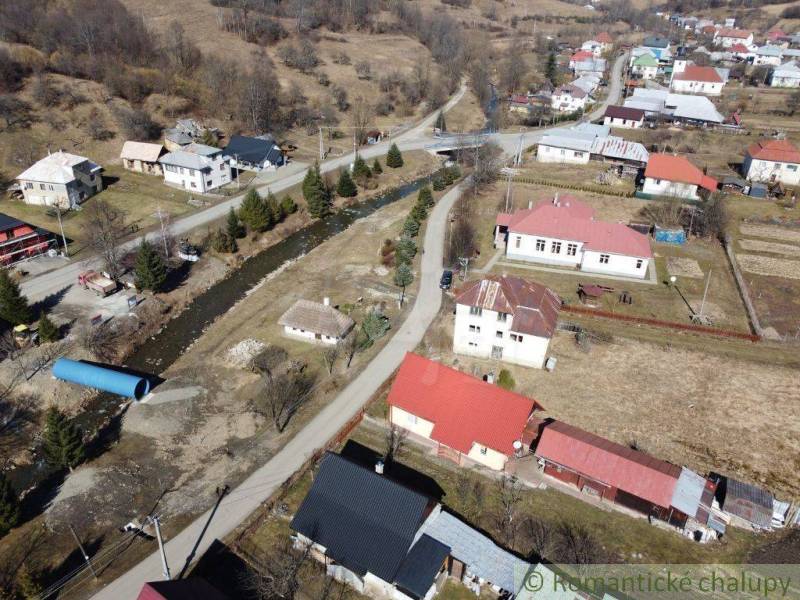 A view of family houses surrounded by nature and a river in Nová Sedlica.