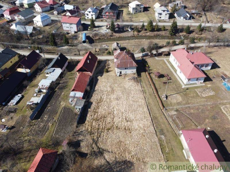 Aerial view of family houses, gardens, and plots in Nová Sedlica.