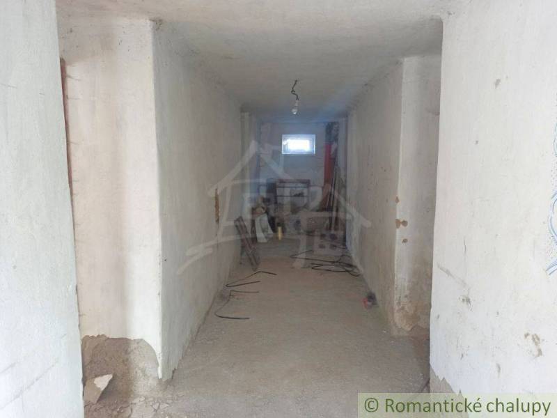 The interior of a family house with a long hallway and visible construction mess.