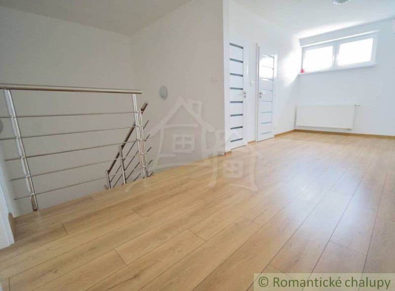 Open space with a staircase and wooden flooring in a family house.