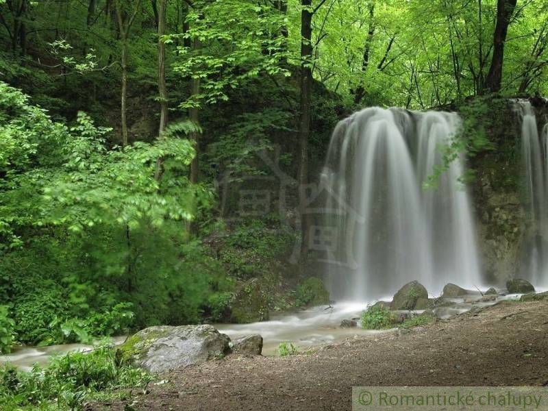 A waterfall surrounded by forest and greenery in nature near Hačava.