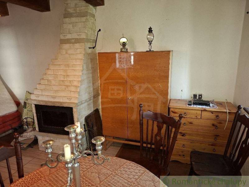 The fireplace and wooden furniture in the cabin create a cozy atmosphere.