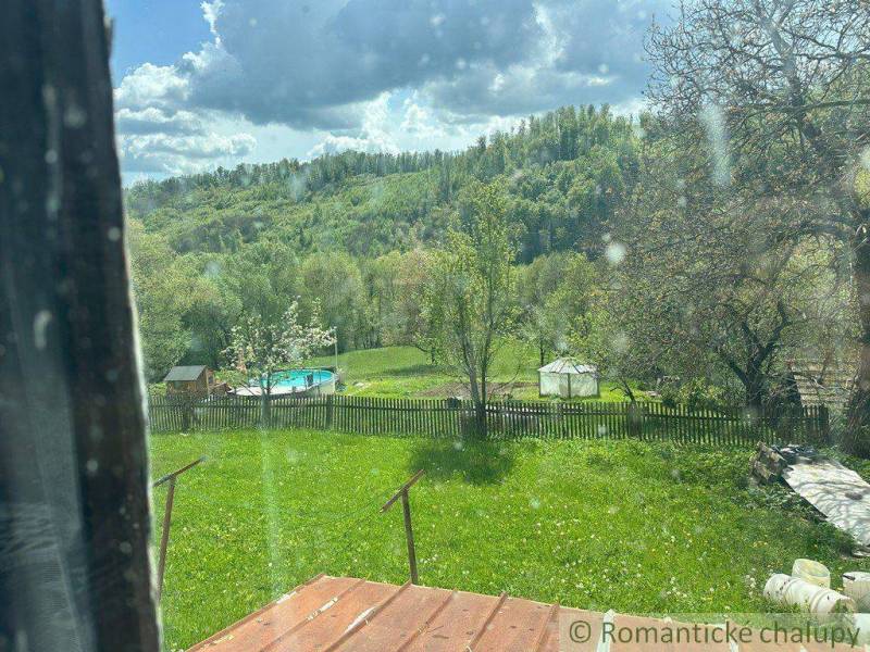 The garden of a family house in Kokava nad Rimavicou with a swimming pool and green landscape.