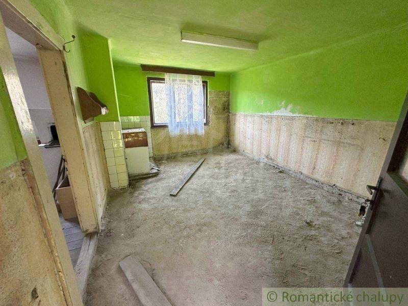 An interior with unplastered walls and an old stove in a family house.