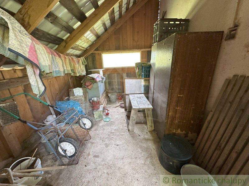 Storage space in a family house with a wooden attic, full of various tools.