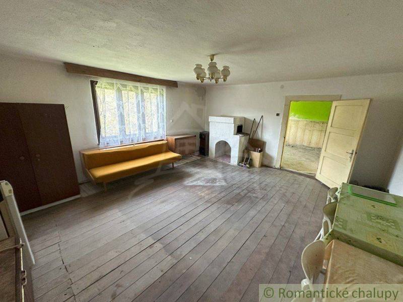 A living room in a family house with wooden flooring and vintage furniture.