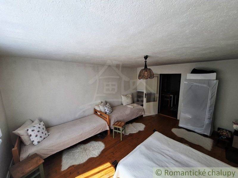 The interior of a family house with beds and a lamp offers a cozy atmosphere.