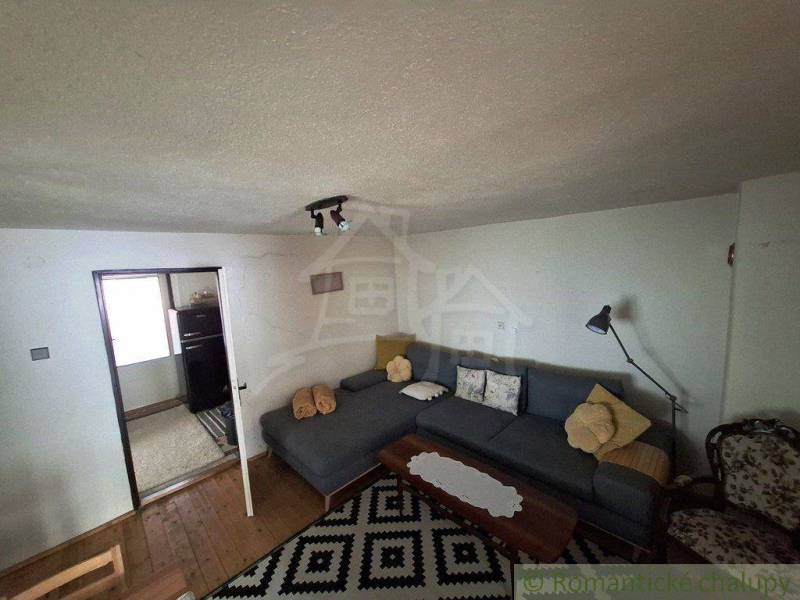 Interior of a family house with a sofa, floor, and lamp in a cozy living room.