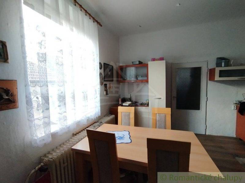 Dining room in a family house, furniture, curtains, window, country style, interior.
