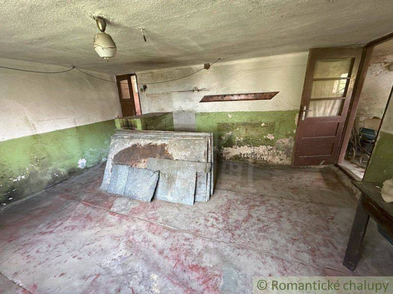 An older room needs renovation, with plaster and flooring requiring repairs in a family house.
