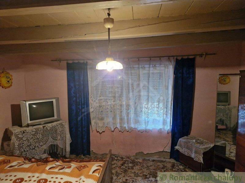 Interior of a traditional room, television, curtain, family house, rustic atmosphere, warm colors.