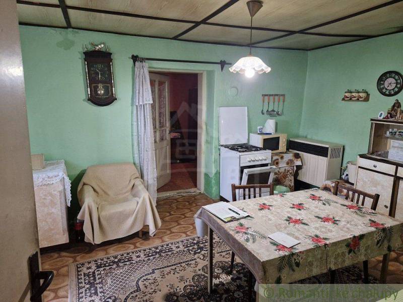 A country family house with vintage furniture, antique clocks, and a kitchen in a historical style.