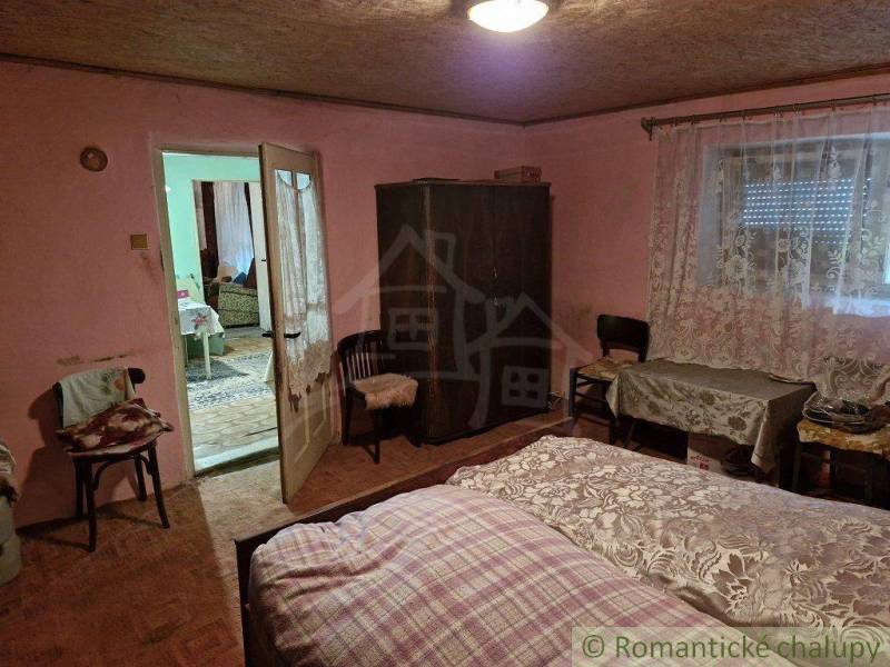 A bedroom in a traditional country house, decorations and comfortable furnishings evoke coziness.